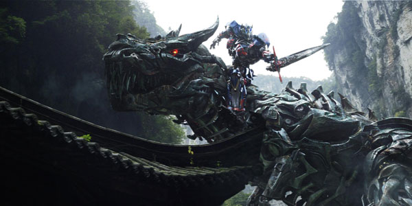 Optimus Prime riding a giant, robot dinosaur. (Source)