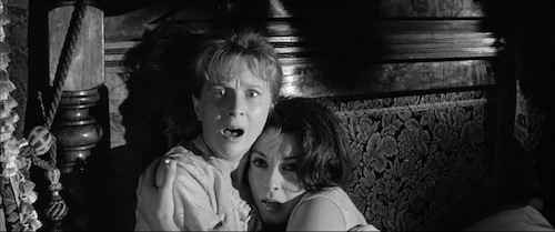 Eleanor (Julie Harris) and Theodora (Claire Bloom) embrace. 