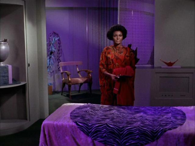 Uhura, off the clock in her quarters, surrounded by pieces of her home on Earth.